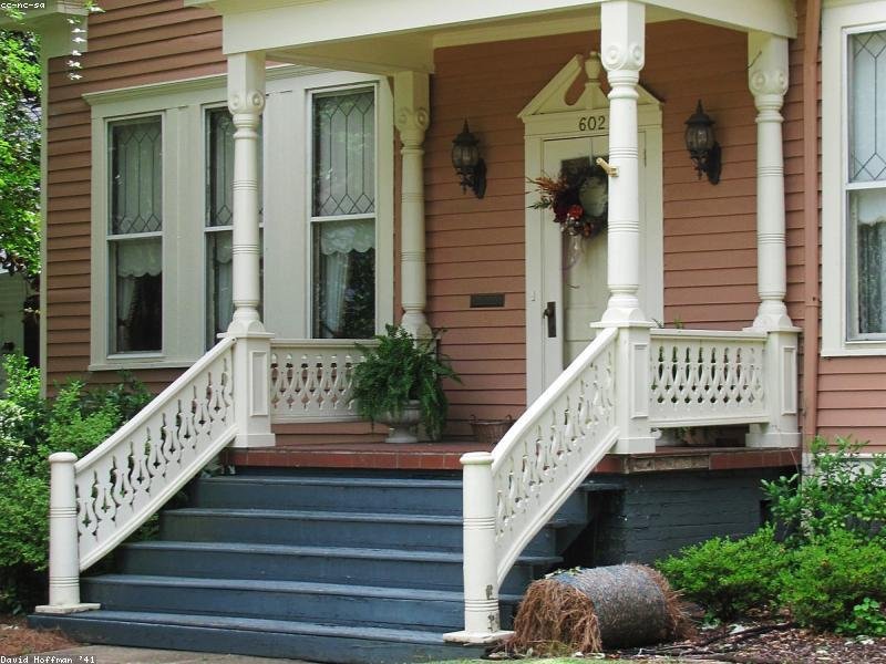Residential entrance with detailed porch stairs and railings